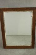 A rectangular oak framed wall mirror, with a silvered slip. H.138 W.108cm.