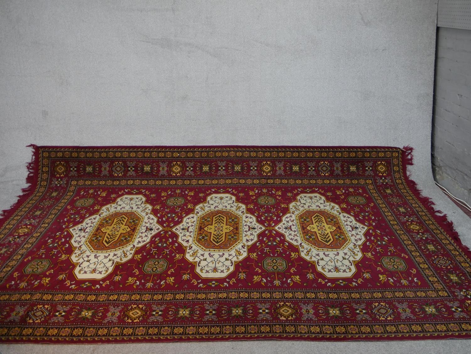 A red ground Heriz motif carpet. L.300 W.196cm