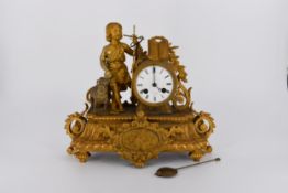 A 19th century French gilt ormolu mantle clock of a Classical figure, young boy with a sheep,