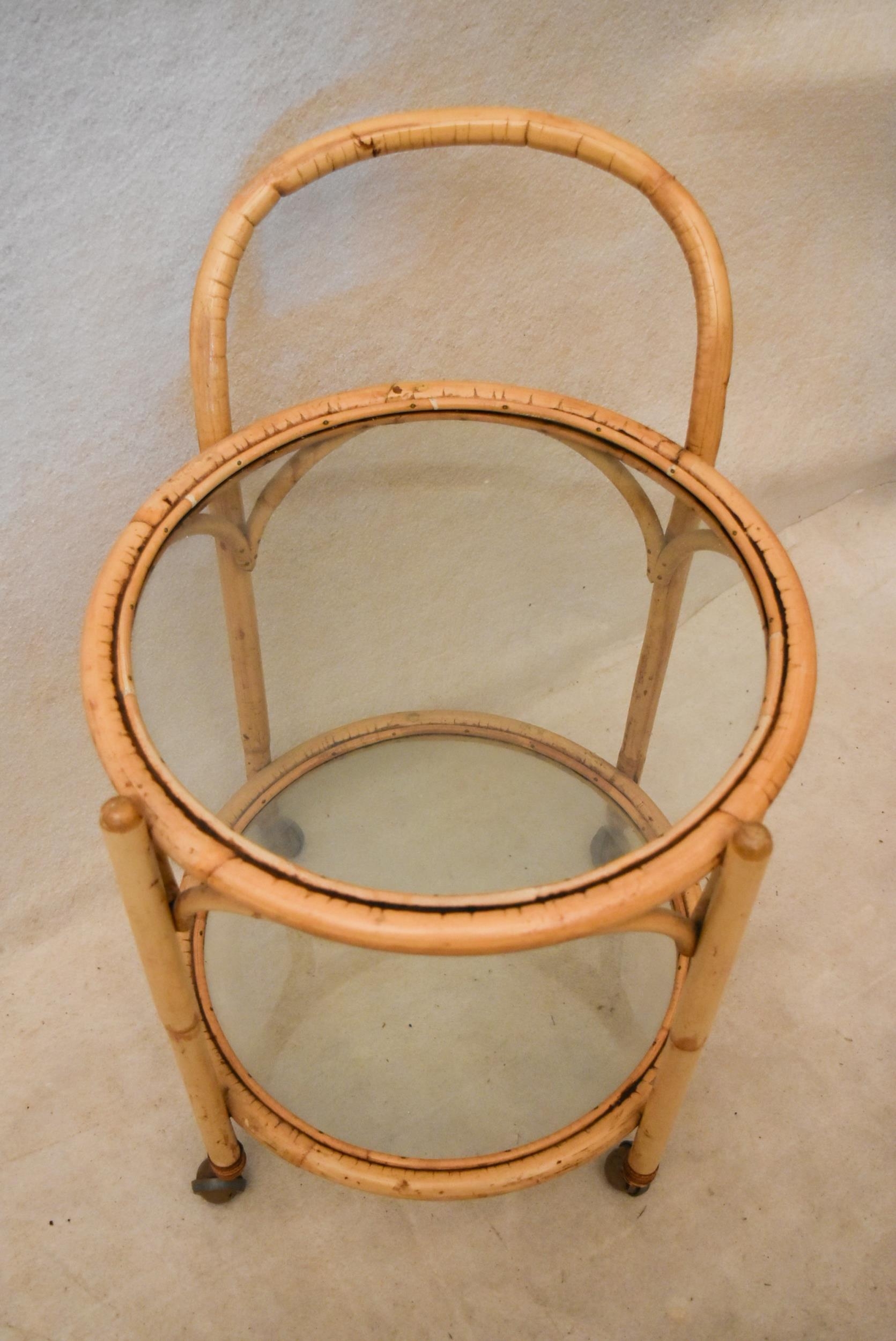 A mid 20th century bamboo drinks trolley, of circular form with two glass tiers. 50cm W x 50cm D x - Image 3 of 3