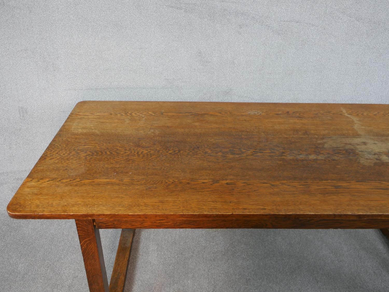 A Heals style Arts and Crafts oak refectory dining table on square trestle supports resting on - Image 3 of 5