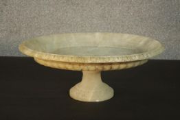 A late 19th/early 20th century oval marble tazza, with a carved border and a lobed side, on a