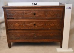 A 19th century French provincial oak commode chest, the plank top over three long drawers, each