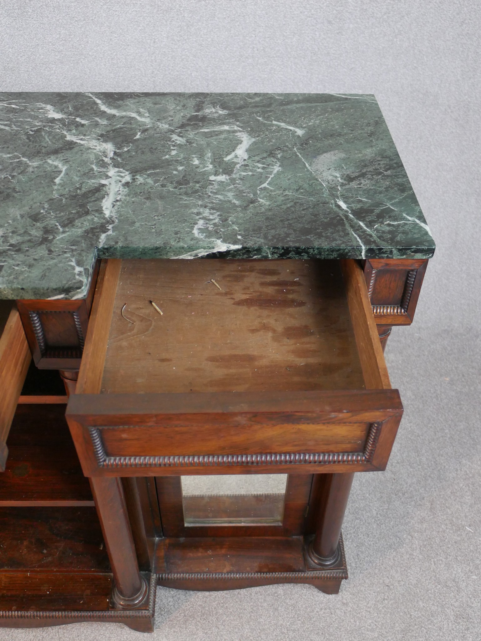 A William IV walnut breakfront sideboard, with a green marble top supported by four columns, with - Image 6 of 7