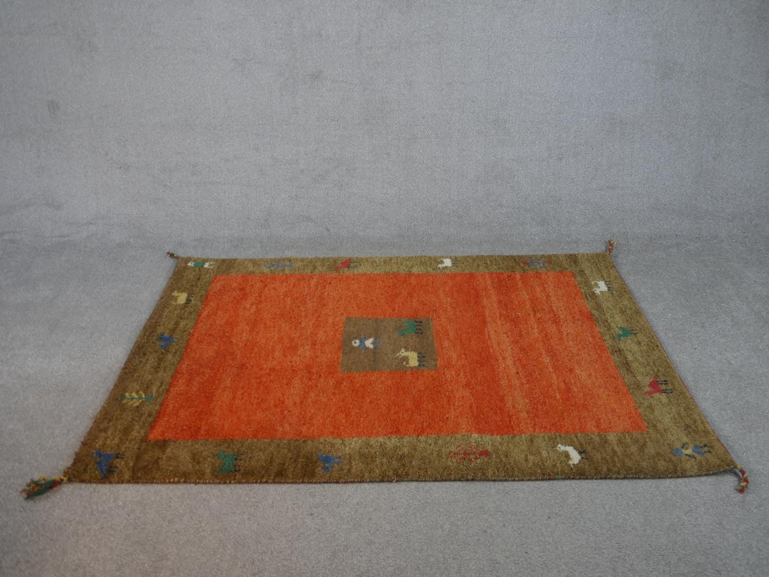 A rust ground hand made Persian Gabbeh rug. L.180 W.122cm - Image 2 of 7