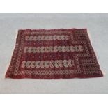 A red ground handmade Persian Turkman rug. L.115 W.100cm