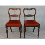 A pair of Victorian walnut kidney back dining chairs, the drop in seat upholstered in red velour, on