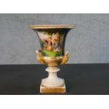 A 19th century hand painted porcelain Classical style urn with figural form handles. One side