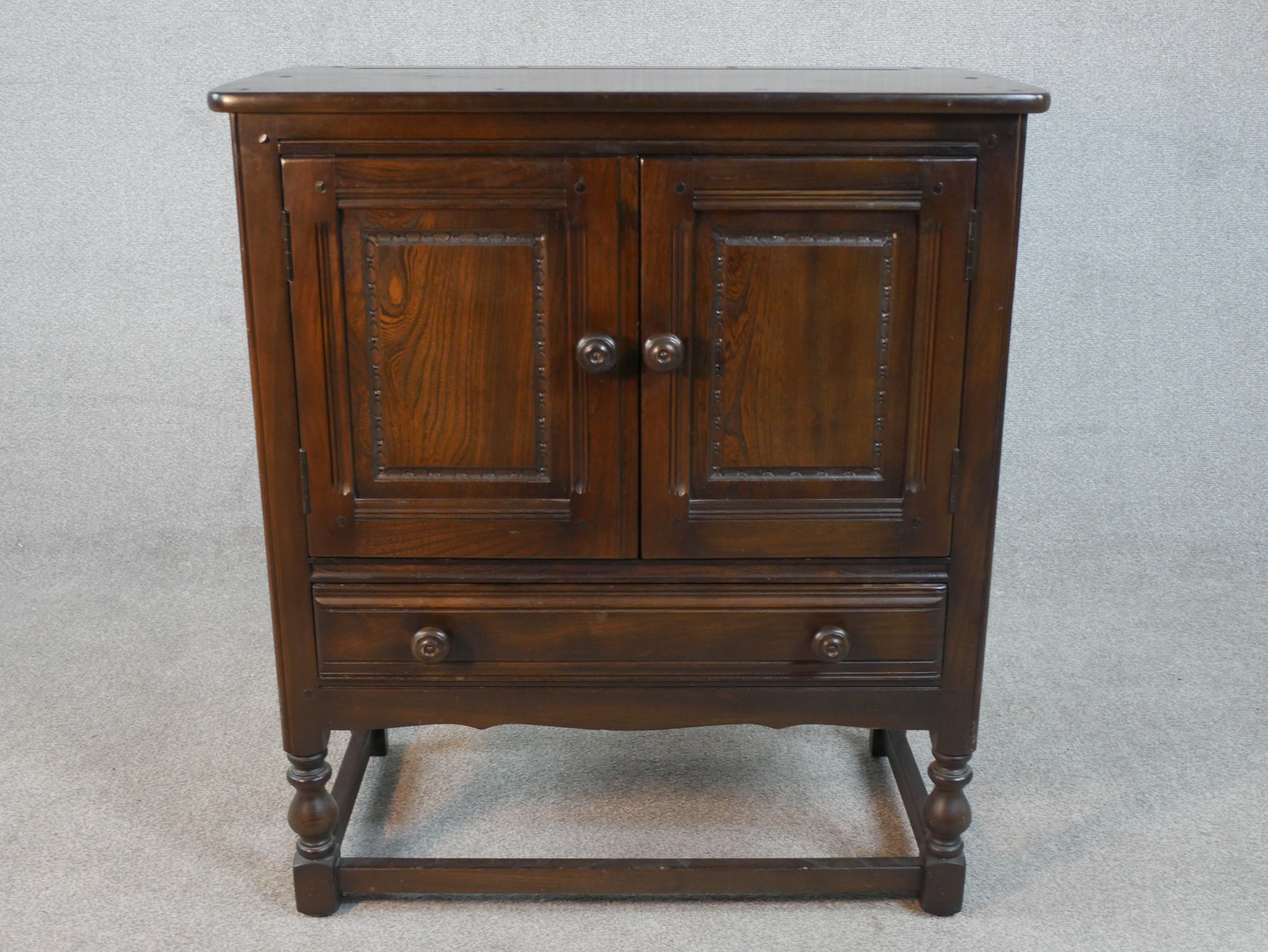 A mid century oak Ercol cabinet in the country antique style. H.70 W.103 D.50cm