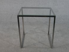 A contemporary cube form occasional table, with a plate glass top on a square section tubular