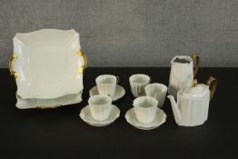 A Wedgwood five person white and gold part tea set. (damage to two cups and coffee pot.) H.14 Dia.