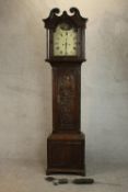 A 19th century carved oak longcase clock, the hood with a swan neck pediment and reeded columns, the