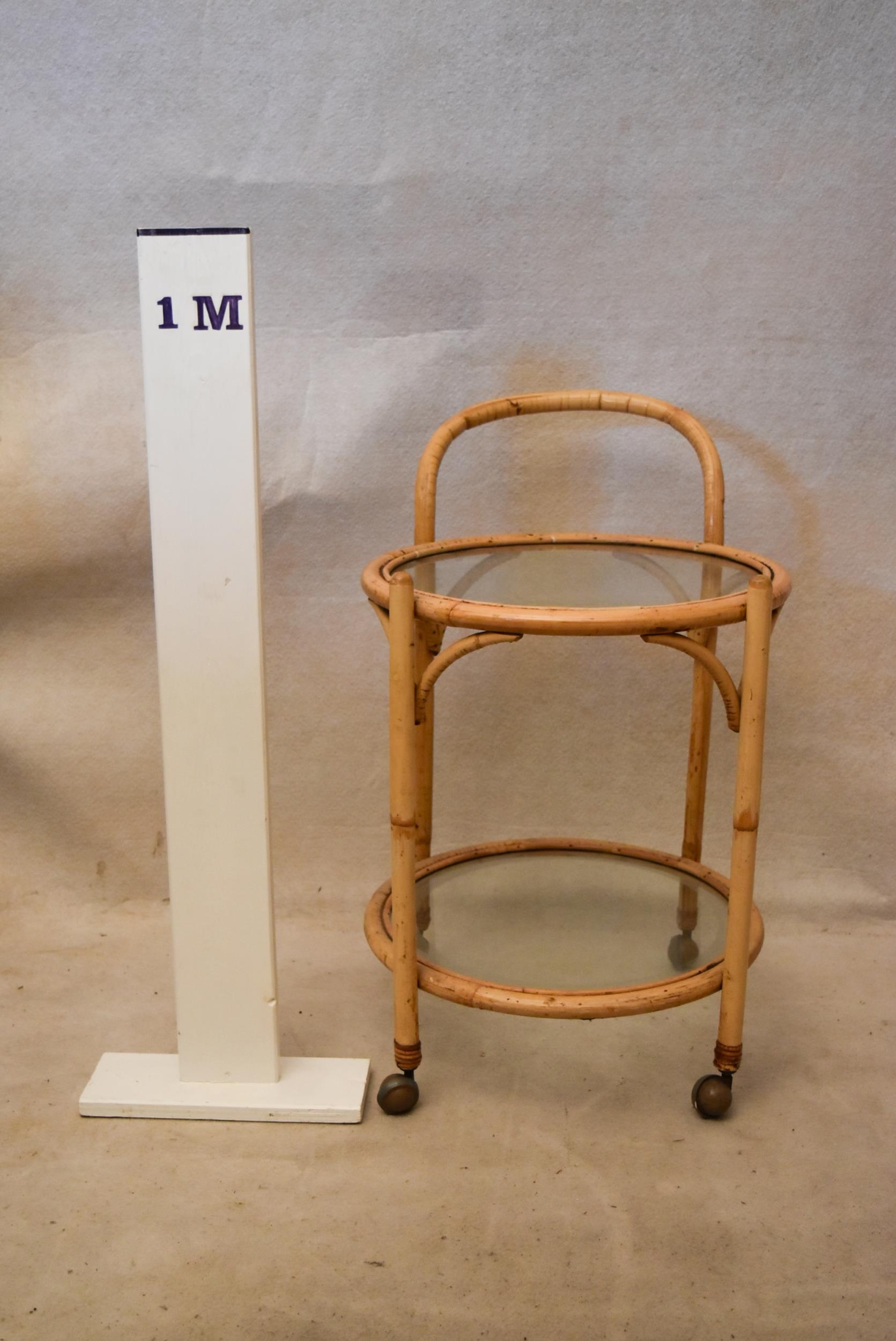 A mid 20th century bamboo drinks trolley, of circular form with two glass tiers. 50cm W x 50cm D x - Image 2 of 3