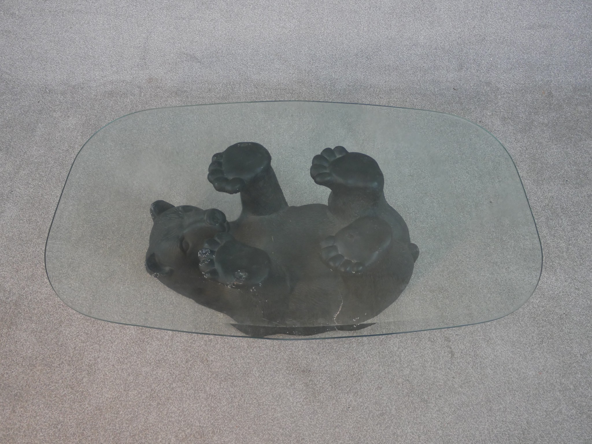 A contemporary glass topped coffee table supported by a moulded and painted bear. H.41 W.105 D. - Image 3 of 4