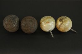 Two carved and polished marble carpet bowls converted into finials along with a pair of iron studded