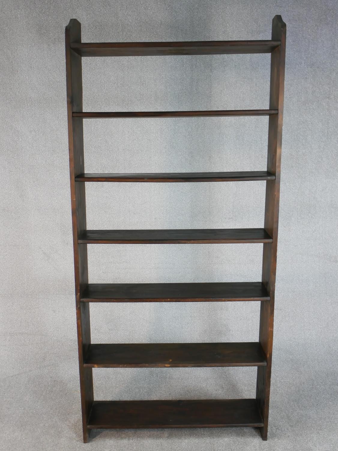 A late 20th century stained pine open bookcase, with seven shelves. H.200 W.92 D.22cm