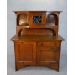 A late 19th century Arts and Crafts oak sideboard with raised superstructure above base fitted