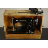 A cased Chapman eletrical sewing machine. H.23 W.35 D.50cm.