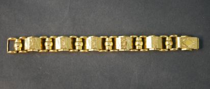 An 18 carat Egyptian yellow gold engraved articulated bracelet, each section engraved with a