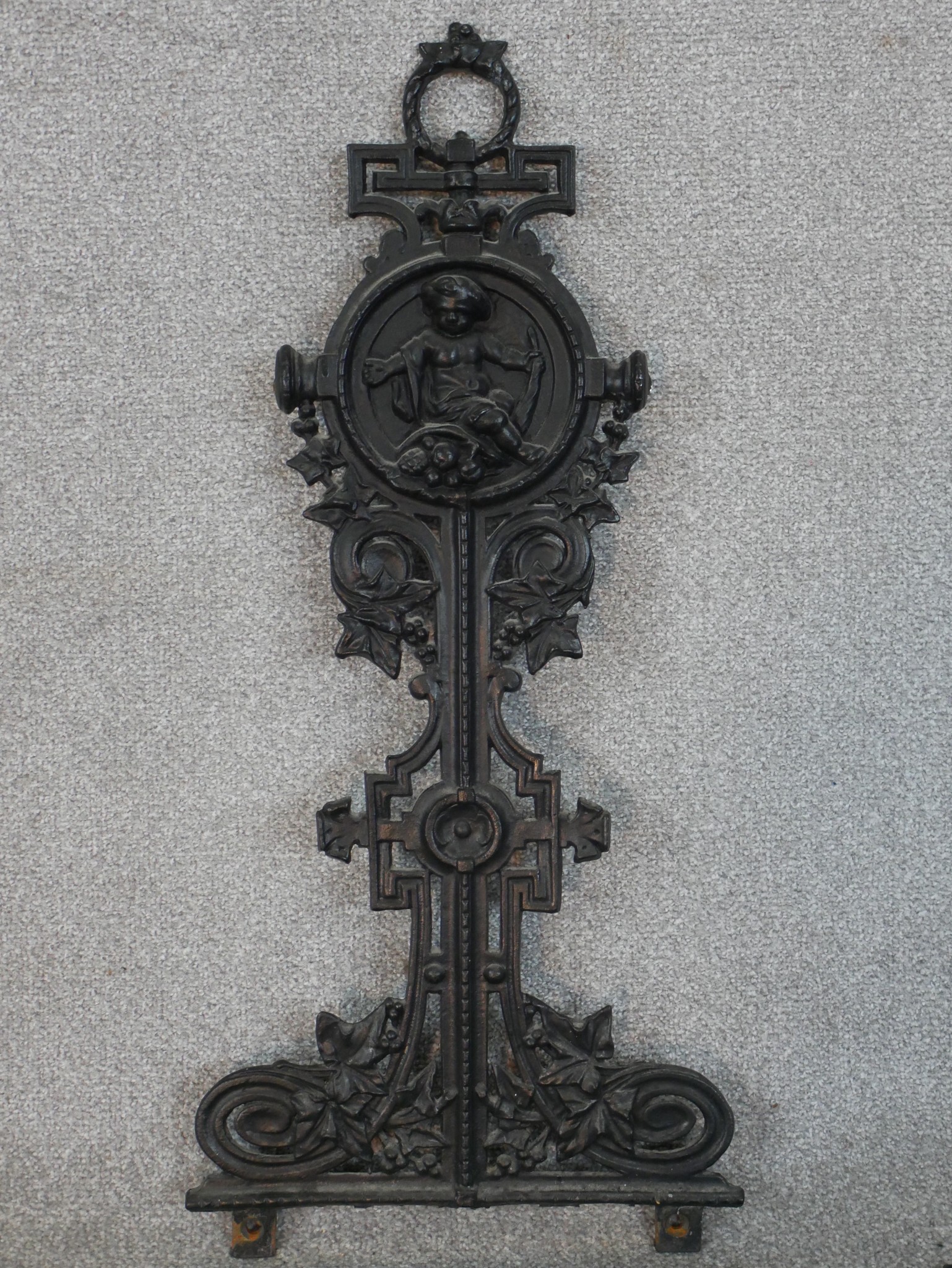 A Victorian black painted cast iron umbrella stand, in four parts, the back cast with a cherub - Image 2 of 6