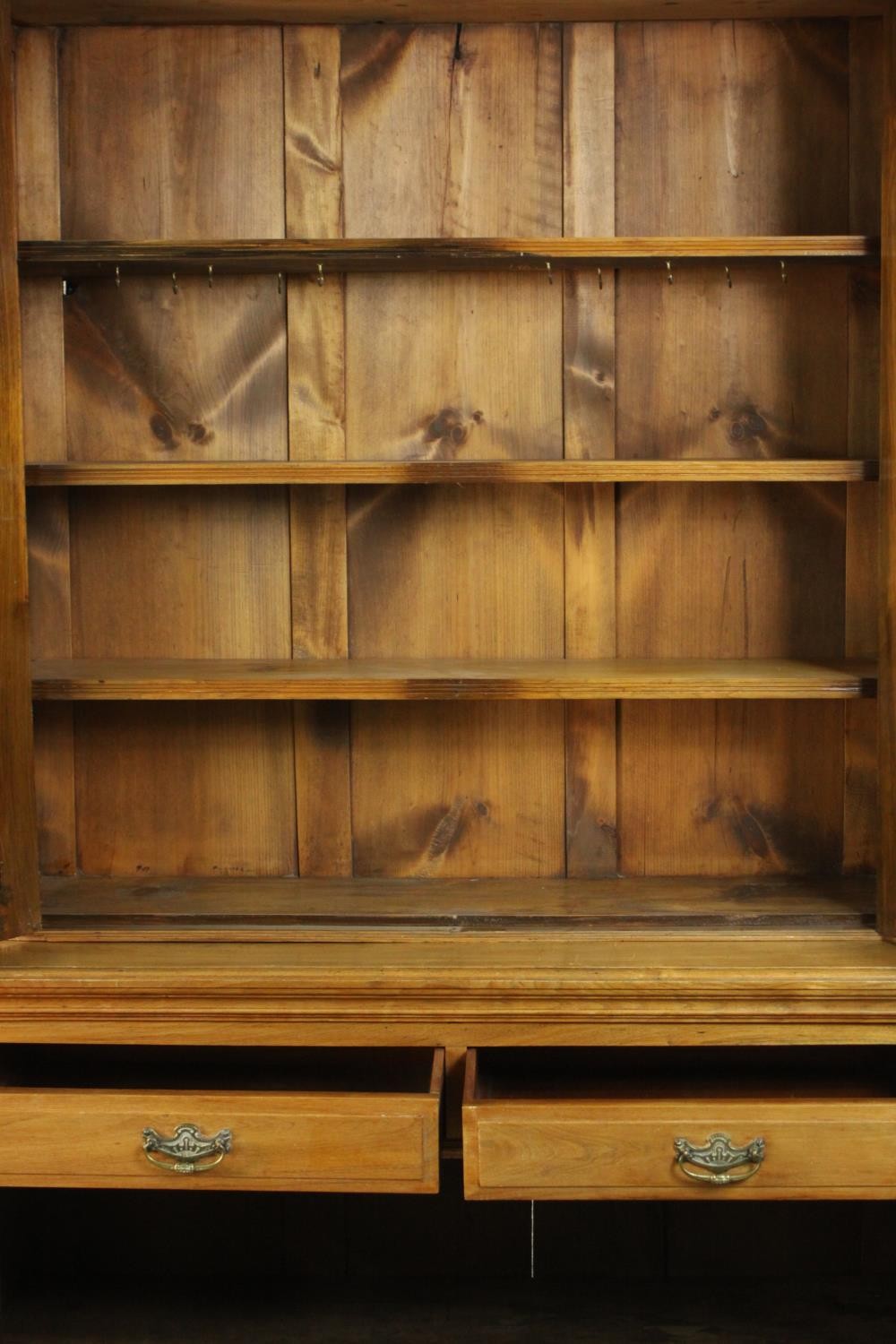 A Victorian style walnut bookcase, the two glazed doors enclosing shelves, over two short drawers - Image 7 of 11