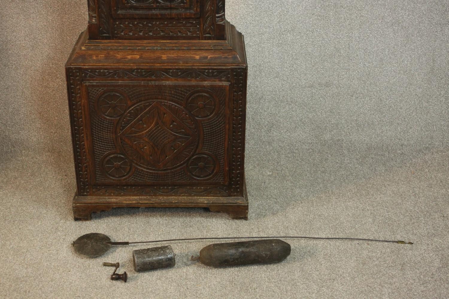 A 19th century carved oak longcase clock, the hood with a swan neck pediment and reeded columns, the - Image 12 of 13