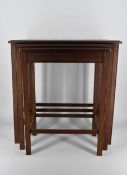 A 20th century nest of three mahogany tables, the rectangular tops with moulded edges, on square