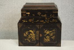 A Japanese black lacquered tabletop jewellery cabinet, decorated with birds and foliage, the