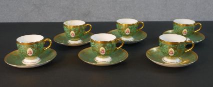 A six person Mintons hand painted green and gilded rose design coffee set. (one cup damaged) 12