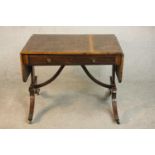 A George III mahogany and crossbanded sofa table with two drop leaves and two drawers, on end