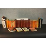 A collection of books, including a set of British encyclopedias, various Penguin books and folio