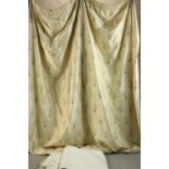 A pair of cream silk embroidered floral design fully lined curtains with pale blue end. L.260 W.