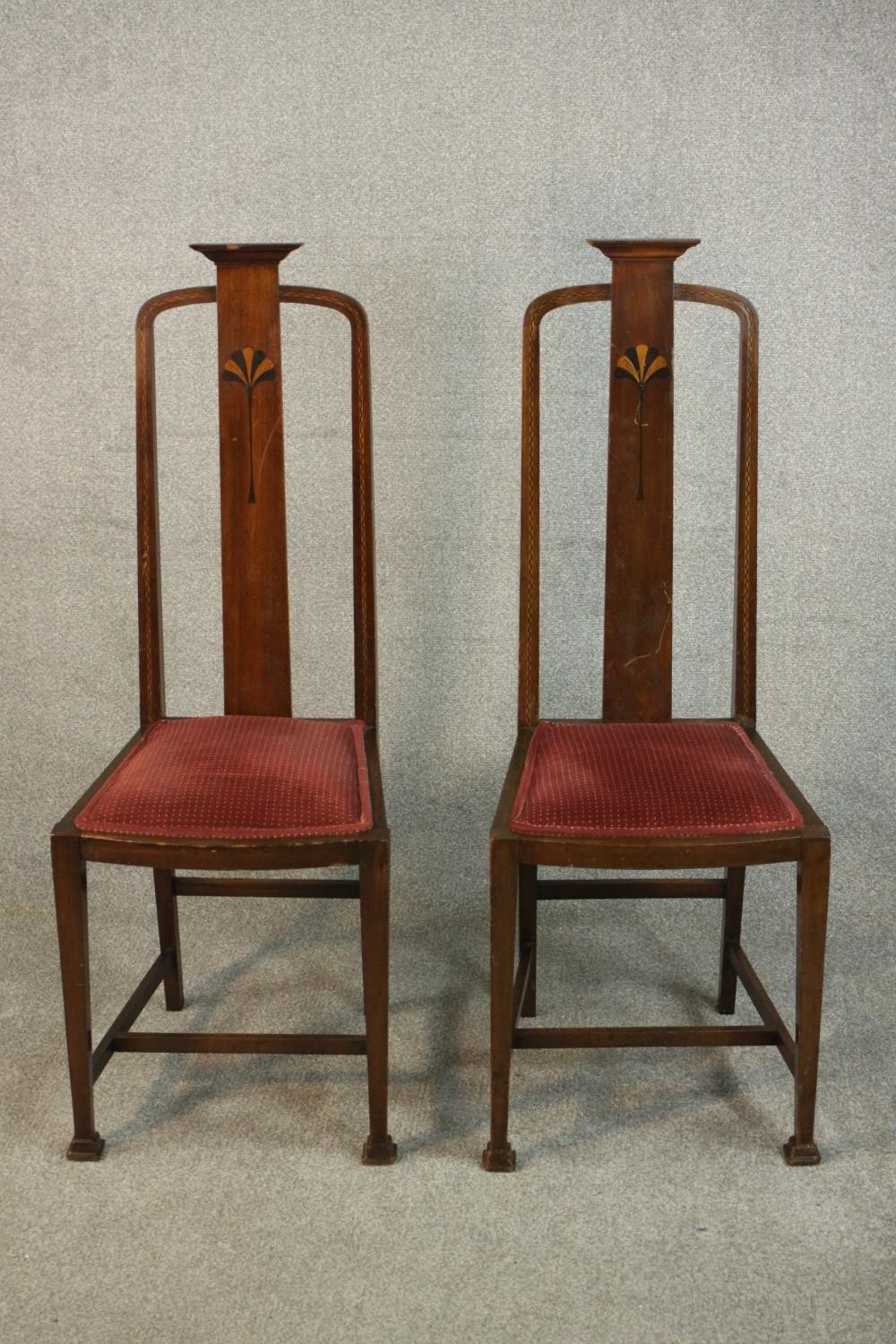 A pair of marquetry inlaid Arts & Crafts oak high back side chairs, the back inlaid with an Egyptian