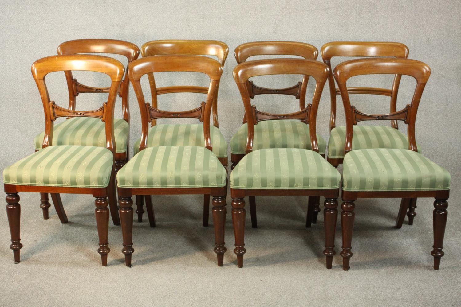 A harlequin set of eight Victorian walnut dining chairs, comprising a set of six side chairs and a