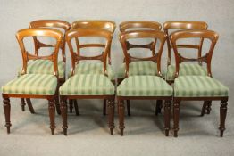 A harlequin set of eight Victorian walnut dining chairs, comprising a set of six side chairs and a
