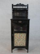 A late 19th century ebonised pier cabinet with mirrored back. H.45 W.55 D.58cm