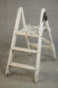 A vintage white painted wooden step ladder, folding and with three steps. H.88 W.35 D.70cm.