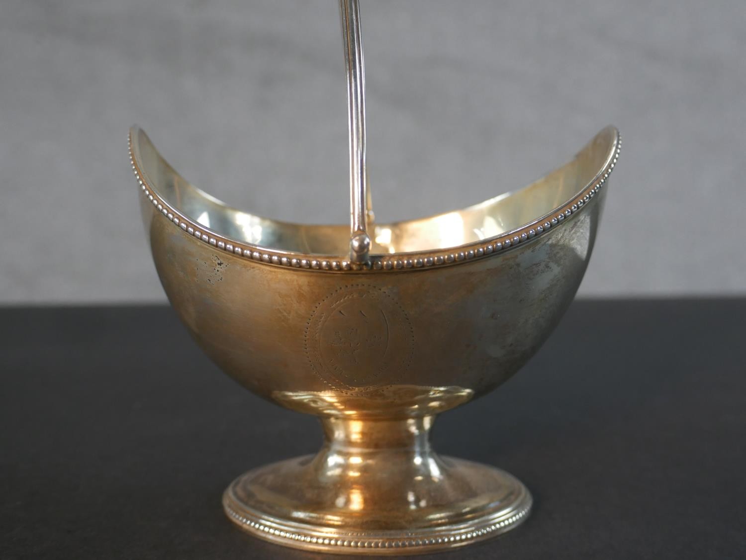 A Georgian sterling silver boat shaped sugar basket with handle and engraved cartouche along with - Image 5 of 6