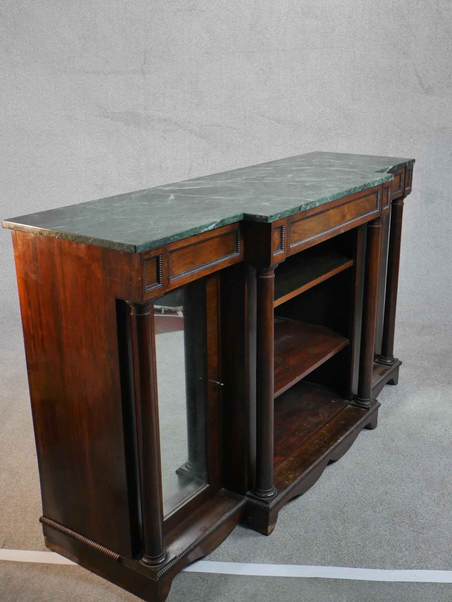 A William IV walnut breakfront sideboard, with a green marble top supported by four columns, with - Image 7 of 7