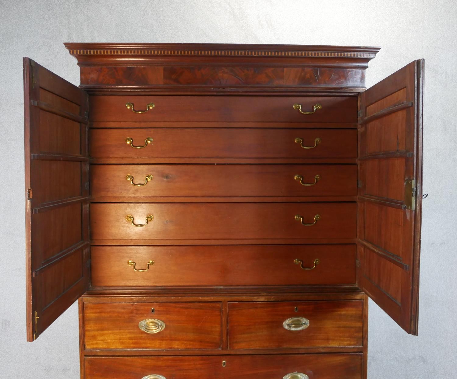 A Georgian mahogany press cupboard the upper section with flame mahogany panel doors enclosing - Image 2 of 7