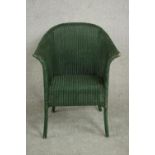 A green painted Lloyd Loom style tub chair.