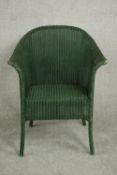 A green painted Lloyd Loom style tub chair.