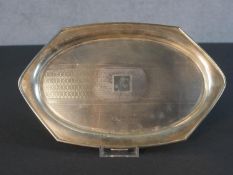 An Art Deco silver engraved and engine turned decorated hexagonal tray. Hallmarked:Davis, Moss & Co,