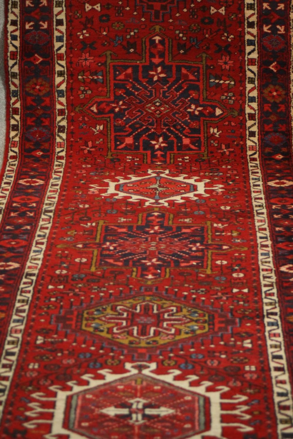 A hand made red ground Persian Heriz runner. L.440 W.100cm. - Image 3 of 5