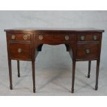 A George III mahogany kneehole bowfront sideboard, with a central drawer over a kneehole flanked