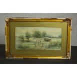 A gilt framed 19th century watercolour of a river landscape with farm workers and horse and haycart,
