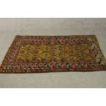 A gold ground hand made Kazak rug. L.151 W.88cm.