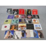 A collection of approximately twent nine vintage vinyl records, including Rod Stewart, Queen and