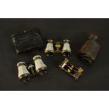 Three pairs of early 20th century opera glasses, each with mother of pearl inlay and a brown leather