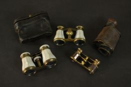 Three pairs of early 20th century opera glasses, each with mother of pearl inlay and a brown leather